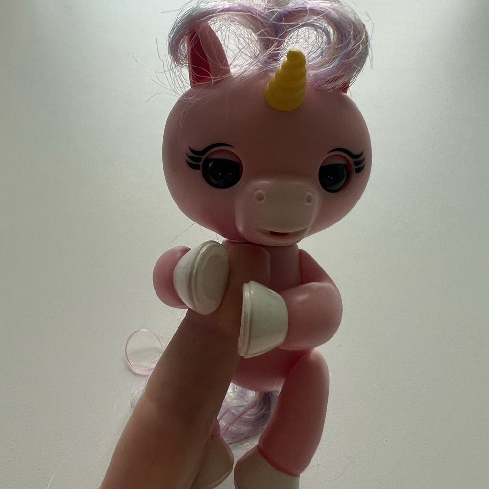 Fingerlings Baby Unicorn Gemma Figure Pink Unicorn Toy with Yellow Horn.